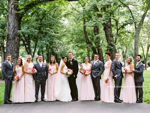 Bride, Groom, and wedding party pose for a photo