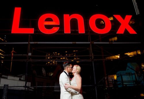 Bride + Groom in front of Lenox rooftop sign