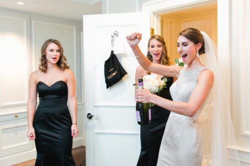 Bride opening a bottle on her wedding day in Boston