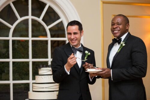 Will and Jerome, the grooms, cut the first piece of their wedding cake