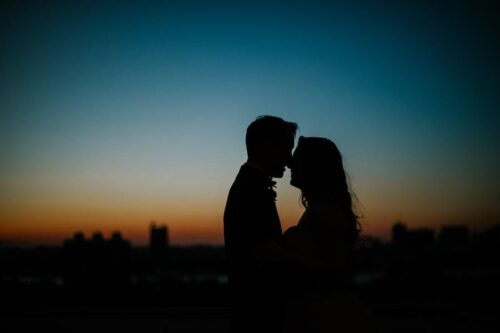 Bride and groom silhouette on roof
