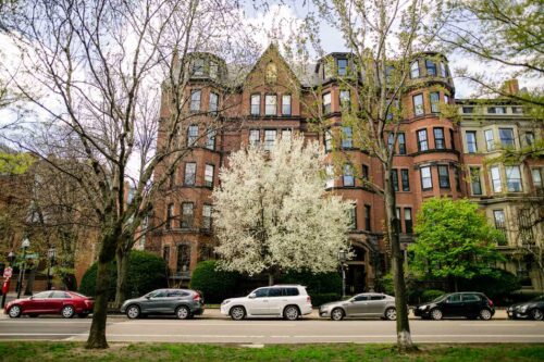 apartment buildings on commonwealth avenue with cars on street