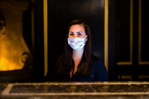 Woman wearing a mask at the front desk