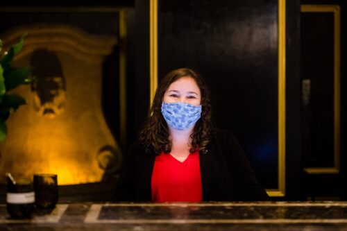 Woman wearing mask at the front desk