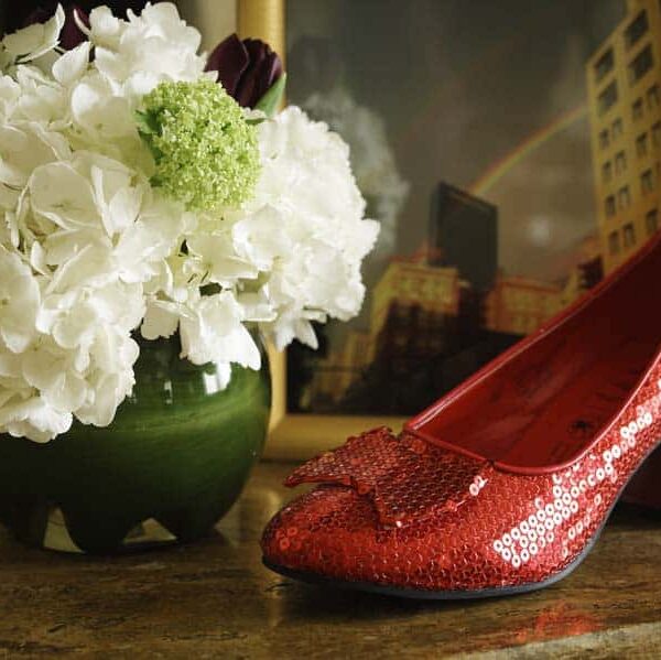 Ruby red high heel shoe and flower arrangment